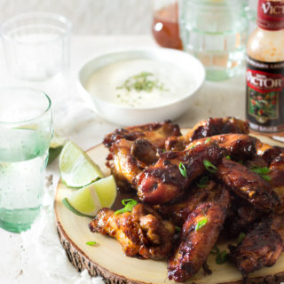 These easy, crispy, sticky, honey ginger marinated chicken wings are slathered in a syrupy spicy carrot hot sauce glaze which is made with melted butter, honey, Don Victor's® unique hot sauce and more. The combination of the smoky hot sauce, which contains carrots as one of the ingredients, plus with my addition of more fresh carrots, gives this chicken a bright lustrous amber color. So delicious you won't be able to stop eating them! I'm not ashamed to say I ate 9 of them! These wings are perfect for lazy weekends, or a great appetizer for game day!
