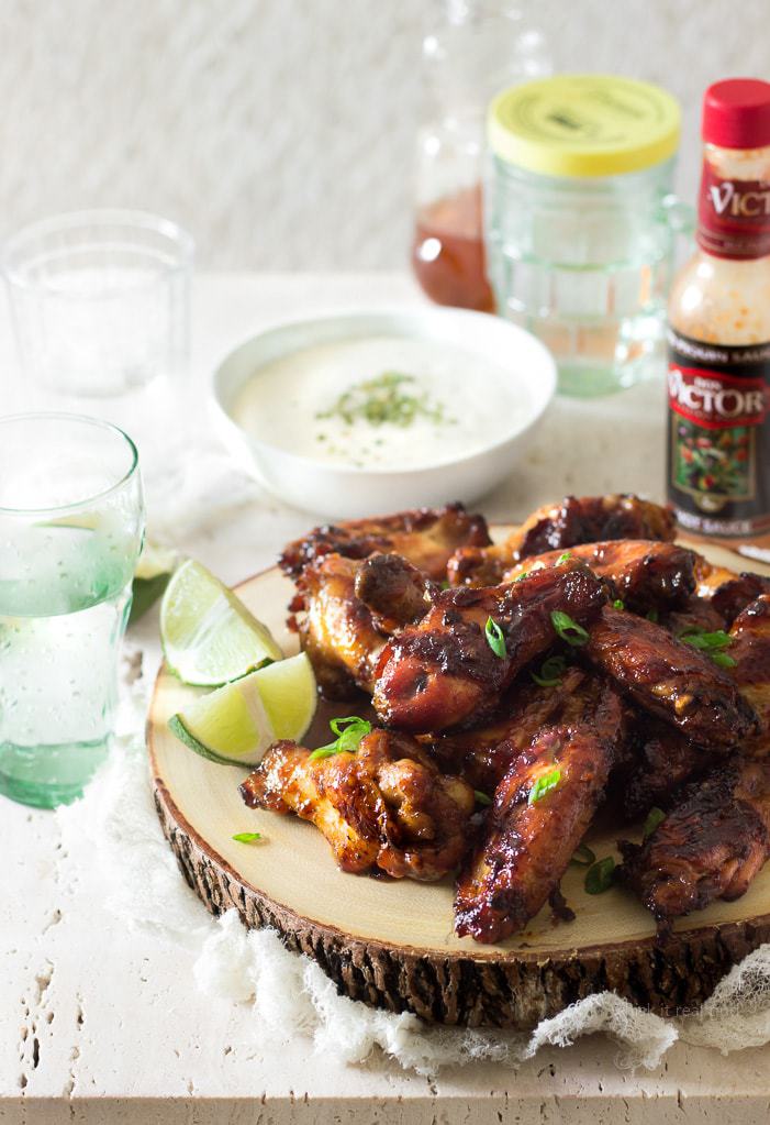 These easy, crispy, sticky, honey ginger marinated chicken wings are slathered in a syrupy spicy carrot hot sauce glaze which is made with melted butter, honey, Don Victor's® unique hot sauce and more. The combination of the smoky hot sauce, which contains carrots as one of the ingredients, plus with my addition of more fresh carrots, gives this chicken a bright lustrous amber color. So delicious you won't be able to stop eating them! I'm not ashamed to say I ate 9 of them! These wings are perfect for lazy weekends, or a great appetizer for game day!