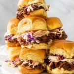 A plate of slow cooked bbq pulled beef inside of hamburger buns