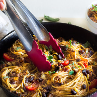 My taco spaghetti is filled with all of my favorite ingredients: Barilla pasta, taco seasoning, ground beef, jalapeno, chipotle, adobo sauce, onions, salsa, black beans, corn, grape tomatoes and fresh herbs. This quick and easy pasta is full of flavor and not too spicy, which makes it kid friendly and perfect for busy weeknights!
