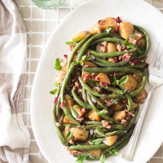 Fresh green beans cooked in a skillet with onions, potatoes and bacon. So delicious, yet so simple to make. Perfect as a Thanksgiving side dish.