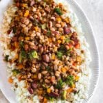 Traditional Hoppin John is thought to bring luck and prosperity. It’s a staple New Year’s day dinner in the south, especially in South Carolina. Classic Hoppin John is made with ham hocks or bacon and cooked in one pot. My quick version uses, smoked sausages and more vegetables like healthy broccoli, frozen black-eyed peas and for kick, a couple pinches of crushed red peppers. This is an easy hearty dish that’s ready in 30 minutes or less.