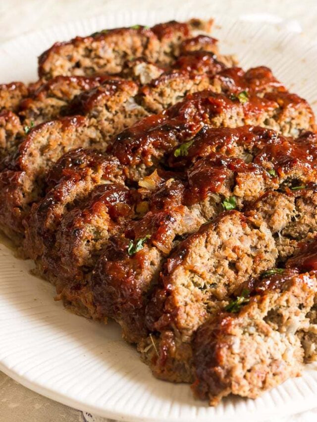 A photo of the Best Meatloaf Recipe with a peppery ketchup and brown sugar glaze on a serving platter