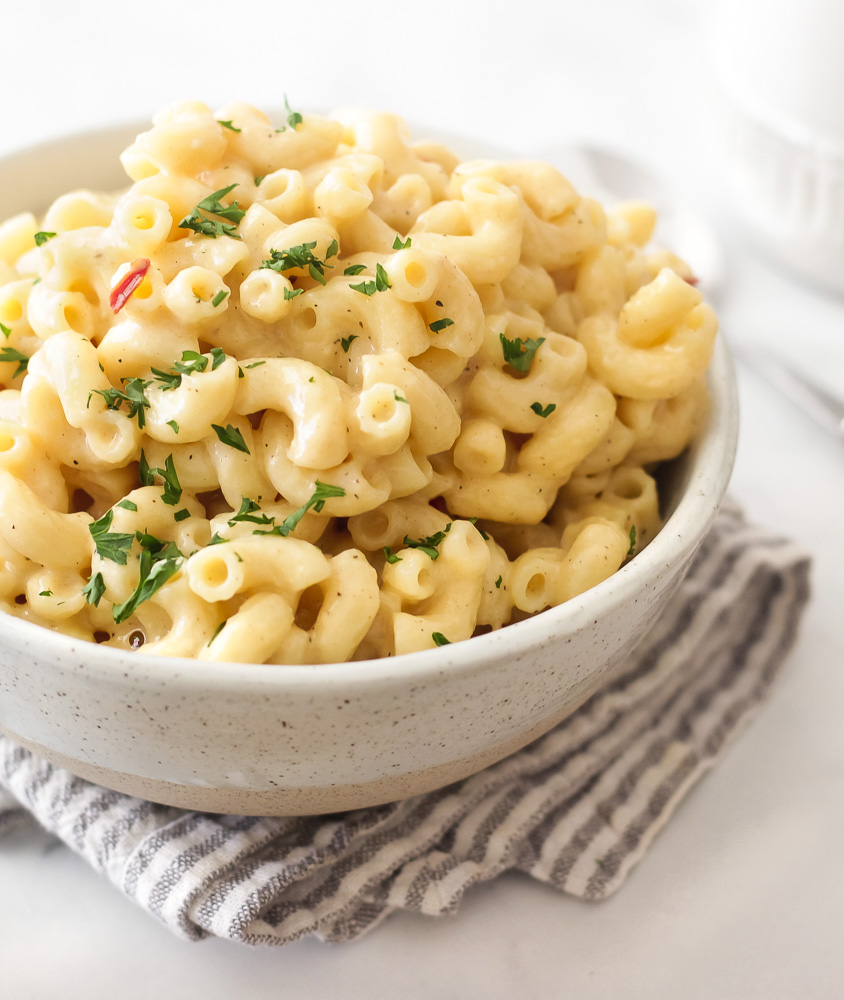 A bowl of creamy stovetop mac and cheese that's cheddar cheese based. Cheesy but not heavy or gloppy.
