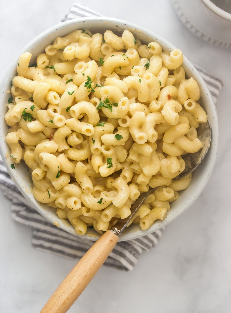 A bowl of creamy stovetop mac and cheese that's cheddar cheese based. Cheesy but not heavy or gloppy.