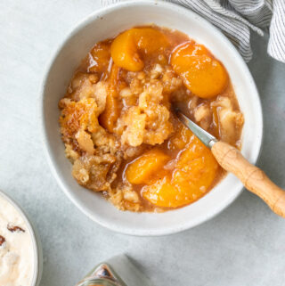 A photo of peach cobbler with a crust like topping