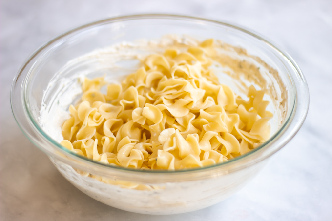 egg noodles with the cream cheese,sour cream and parmesan mixture. 