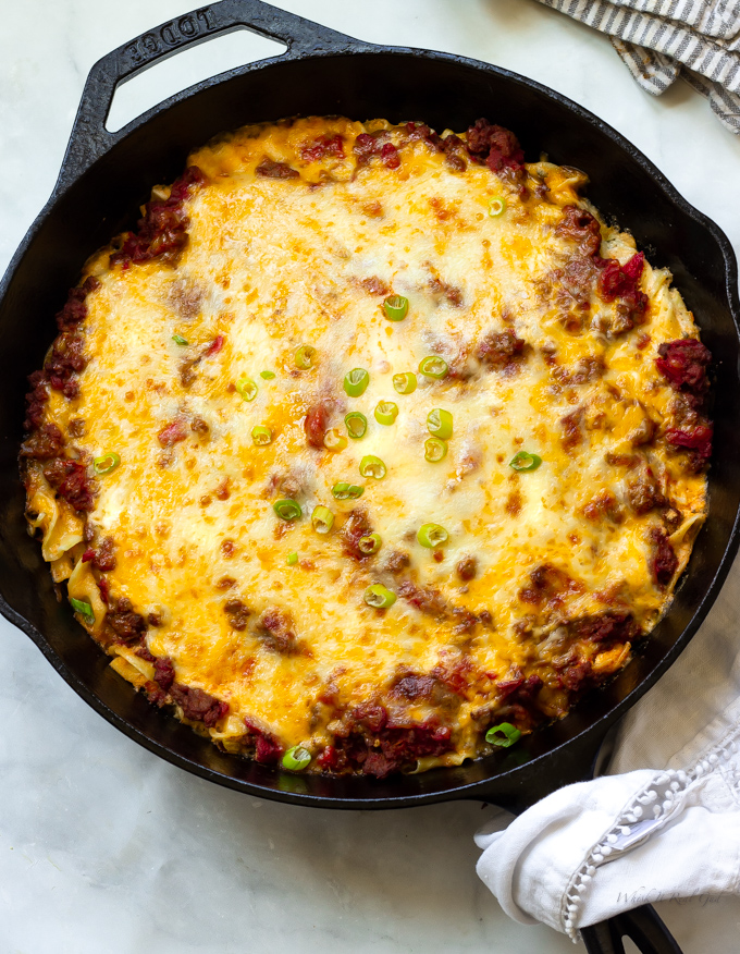Ground beef egg noodle casserole topped with melted cheeses