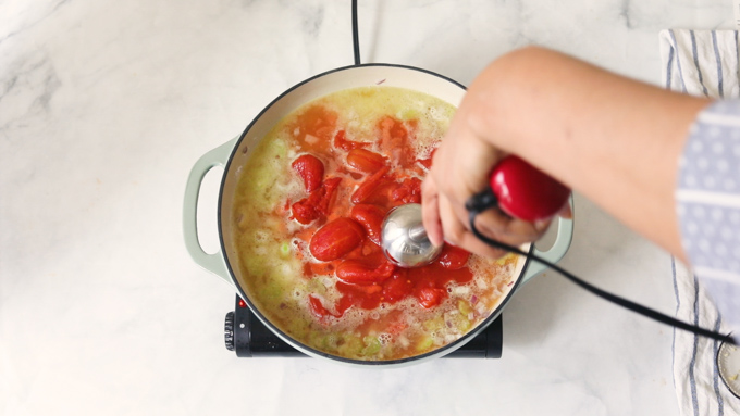 Using an immersion blender to puree the soup