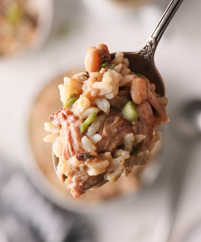 A picture of a spooful of Hoppin John with rice 