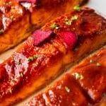A closeup picture of a plate of rhubarb roasted salmon on a white plate