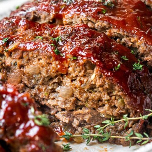 A photo of Ritz Cracker meatloaf on a plate with sweet and spicy glaze