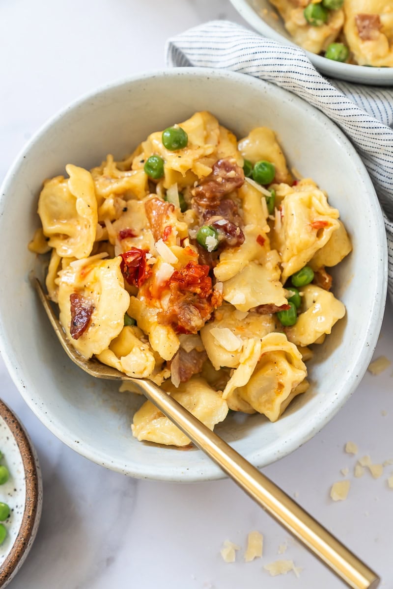 Bowl of creamy tortellini carbonara with bacon and parmesan